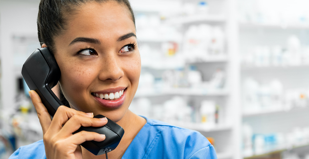 pharmacy-technician-communicating-on-phone-to-customer